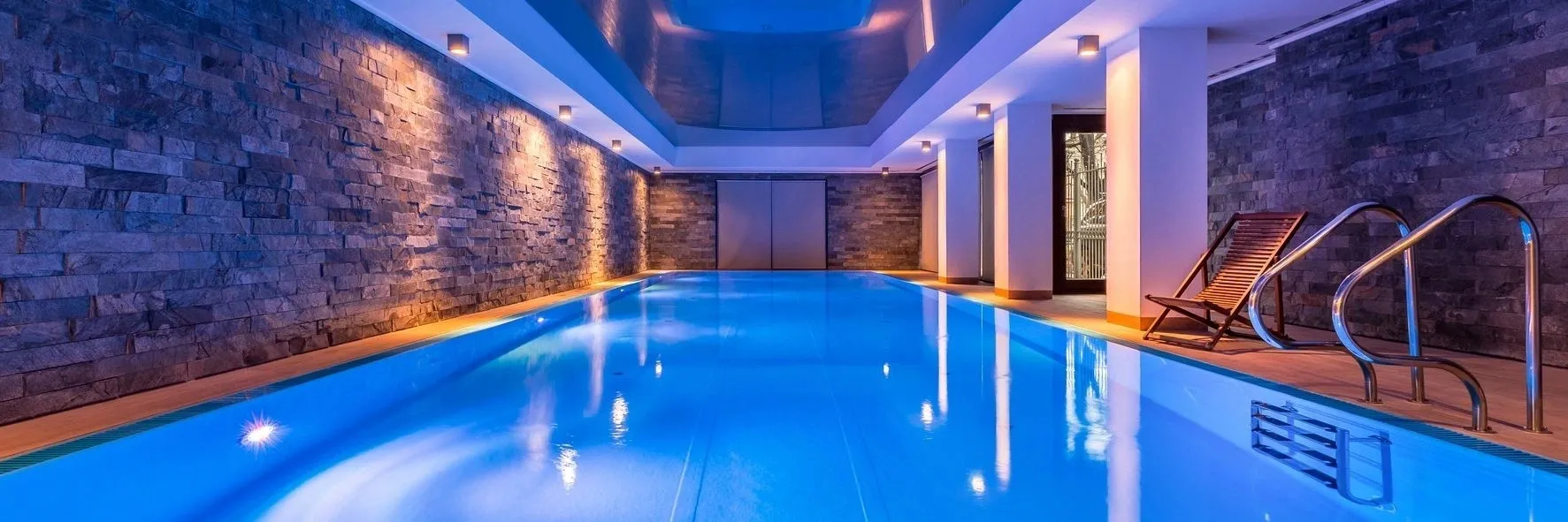 A pool with lights on in the middle of it